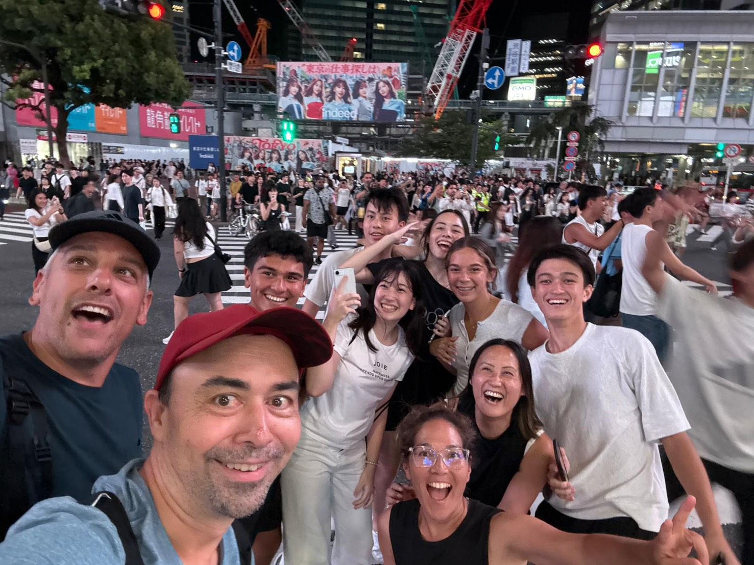 Crossing Shibuya scramble together at night